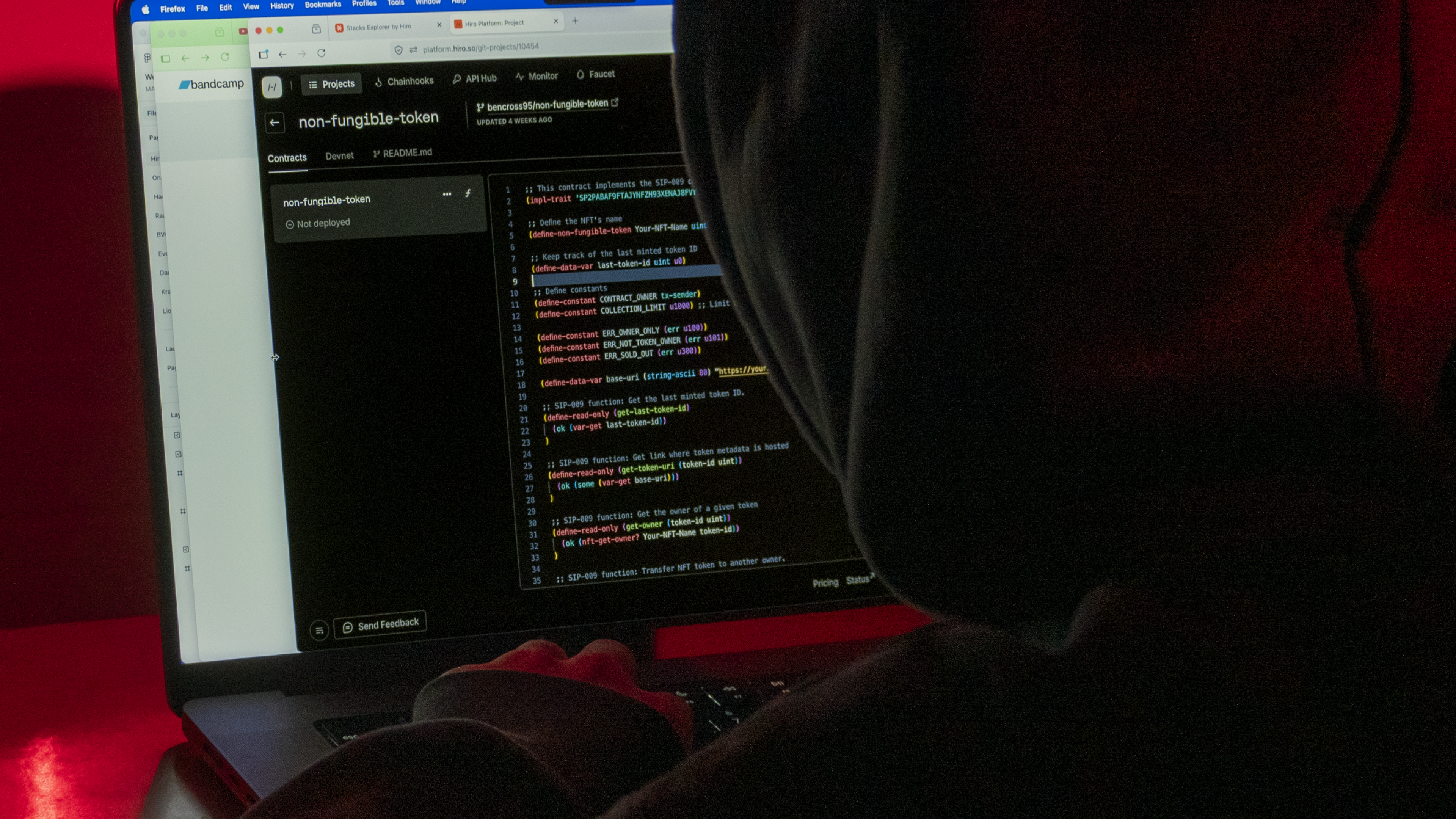 Developer's hands on a laptop in a dark moody environment