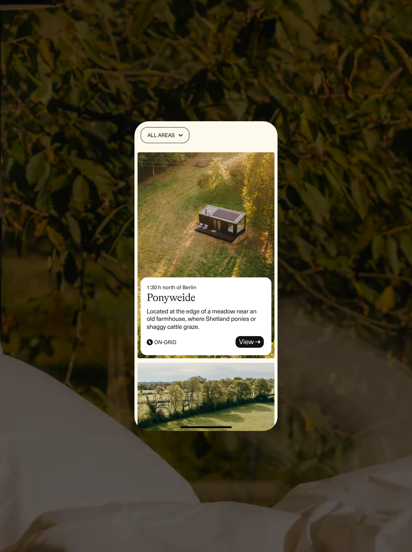 Raus mobile app cabin listing "Among the apple trees" with an aerial drone shot of a Raus cabin in a green meadow